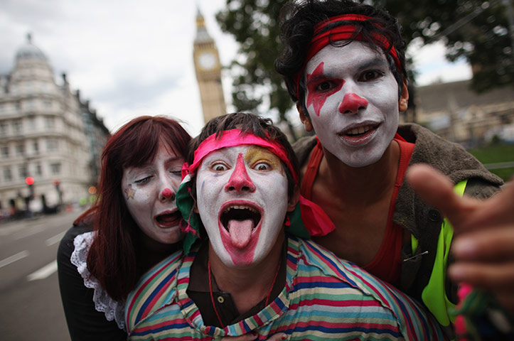 National strikes: People dressed as clows pull faces during march 