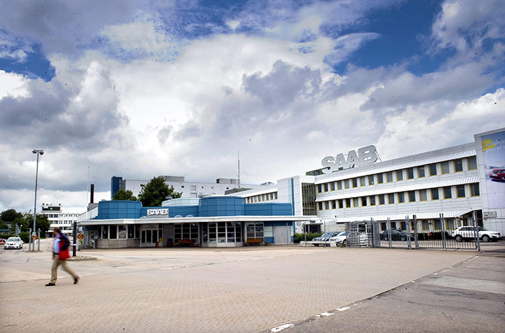 Business Week: A person walks in front of Saab factory