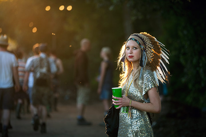 Glastonbury: A woman wearing and Indian head-dress, Glastonbury festival