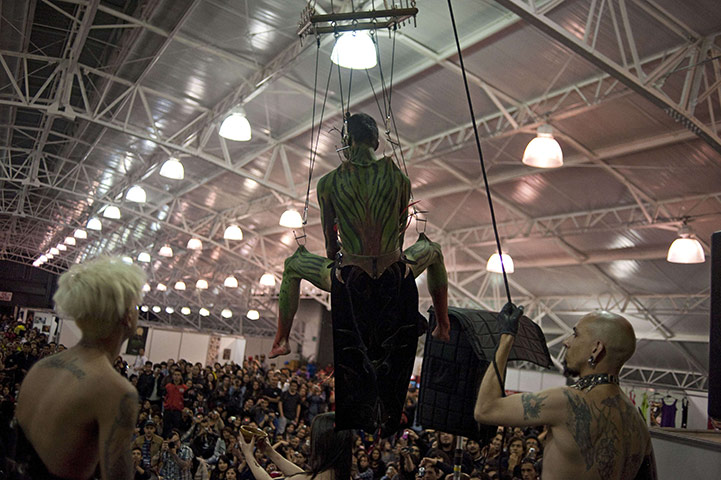 24 hours in pictures: A man hangs in from hooks stuck in his body during aTattoo Convention