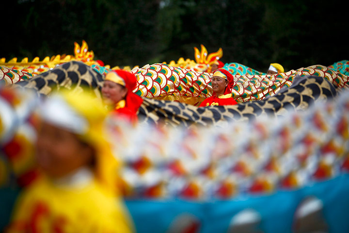 24 hours in pictures: Performers stand next to dragon tails at Dragon Boat Festival, China