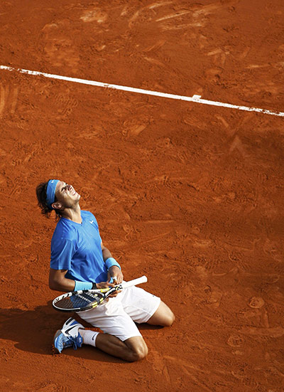 French open final: Nadal of Spain reacts after defeating Federer