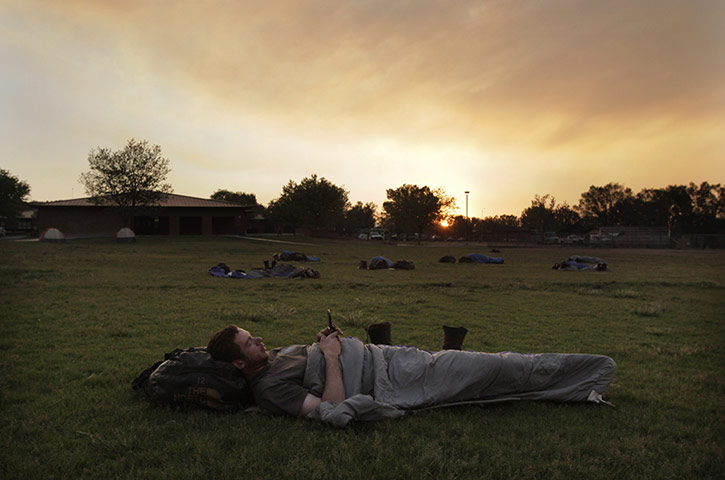 24 hours: Eagar, Arizona, USA: A firefighter rests after battling the Wallow fire