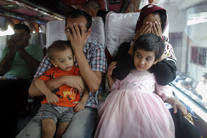 24 hours: Bangkok, Thailand: Pakistani refugees pray as they leave a detention centre