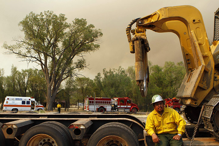 Arizona Wildfires: A firefighter waits to receive orders while he takes a break
