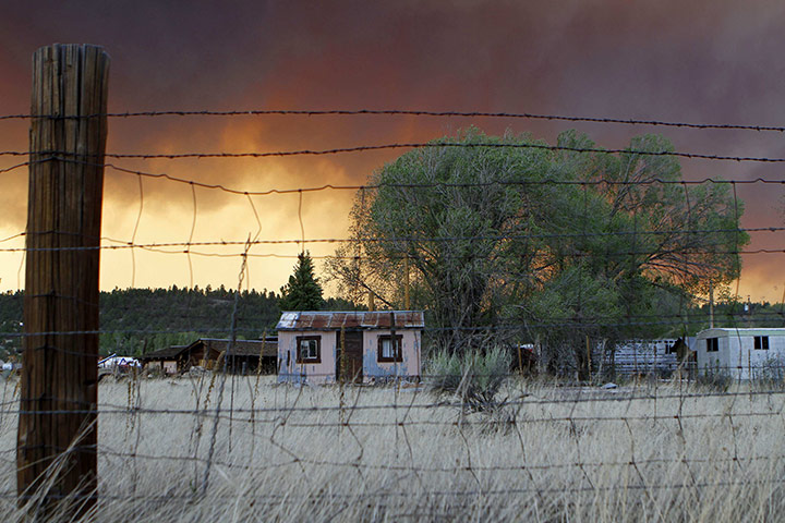 Arizona Wildfires: House are seen along the U.S. Route 180 as smoke fills the sky