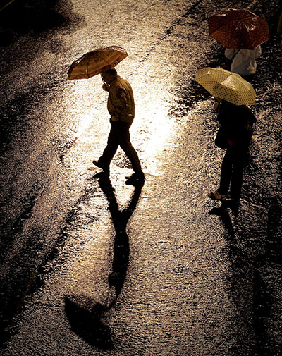 24 hours in pictures: People wit umbrellas walk in the rain on the Puerta del Sol square