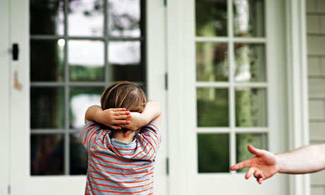 A man reaches out to his autistic son