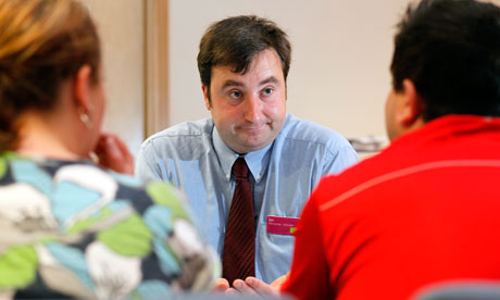 A jobcentre member of staff with two jobseekers