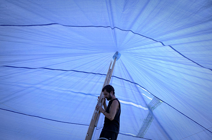 24 hours in pics: A man sets a tent at the Puerta del Sol square, Madrid