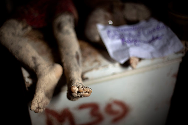 24 hours in pics: The bodies of two children who died in a landslide, Haiti