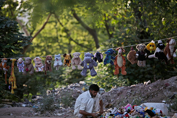 24 hours in pics: A Pakistani vendor displays his toys on a roadside
