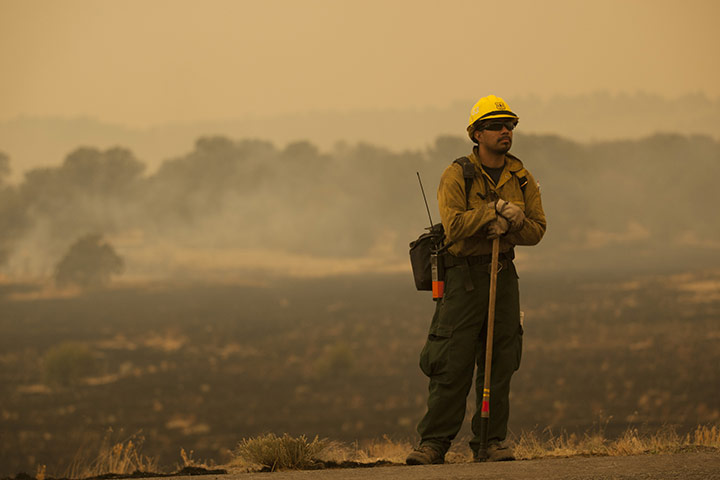 Arizona Wildfires: Firefighter Rigoberto Torres watches a backburn