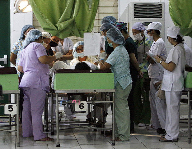 Manila maternity: Medical staff surround a woman who is about to give birth 