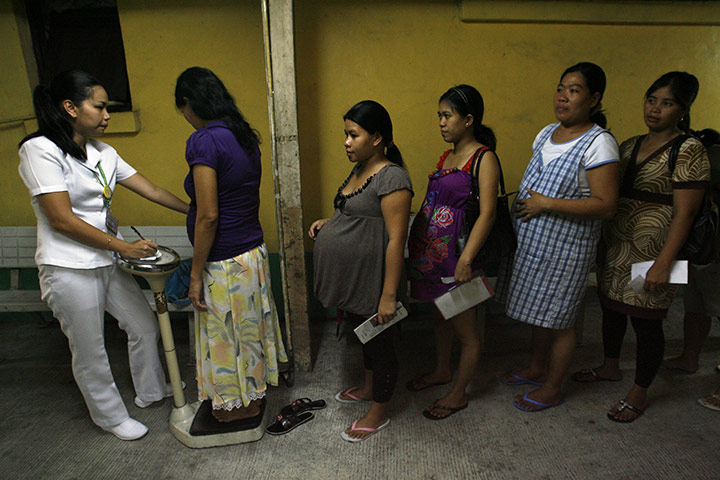 Manila maternity: Women stand in line to get weighed during a pre-natal check 