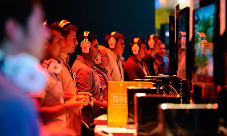 Gamers play video games at the XBOX 360 booth during the E3 expo