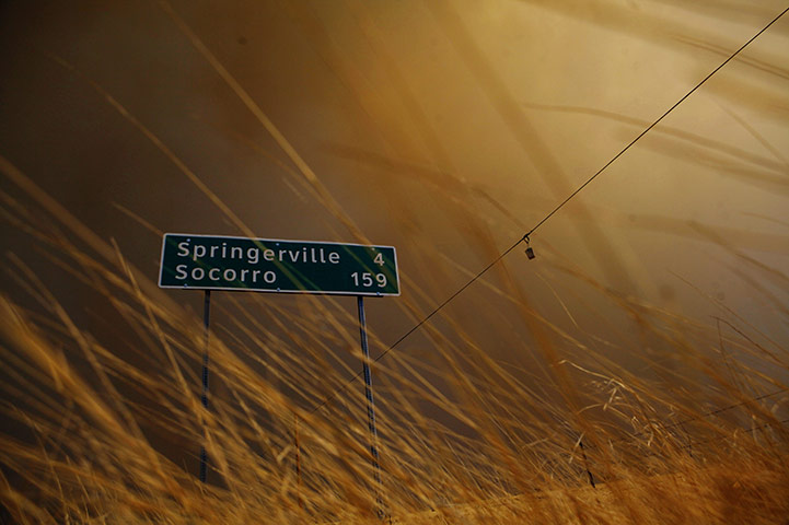 Arizona Wildfires: Smoke is seen by a road sign