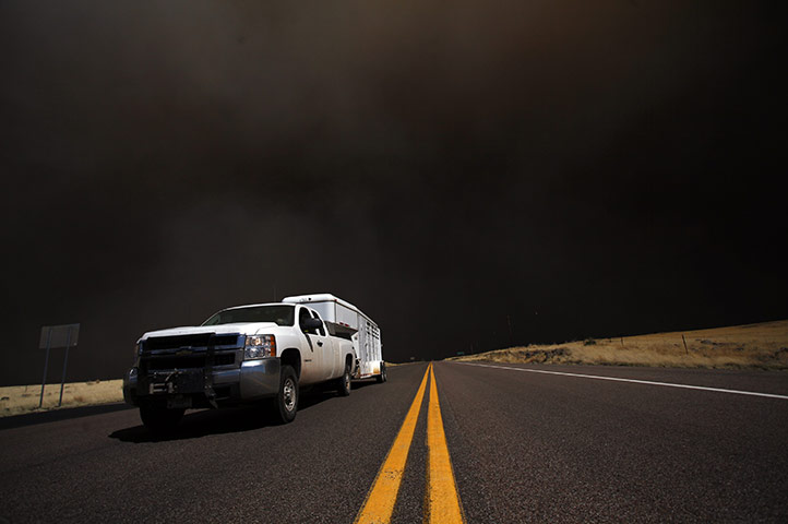 Arizona Wildfires: A truck departs after a main highway into town was restricted