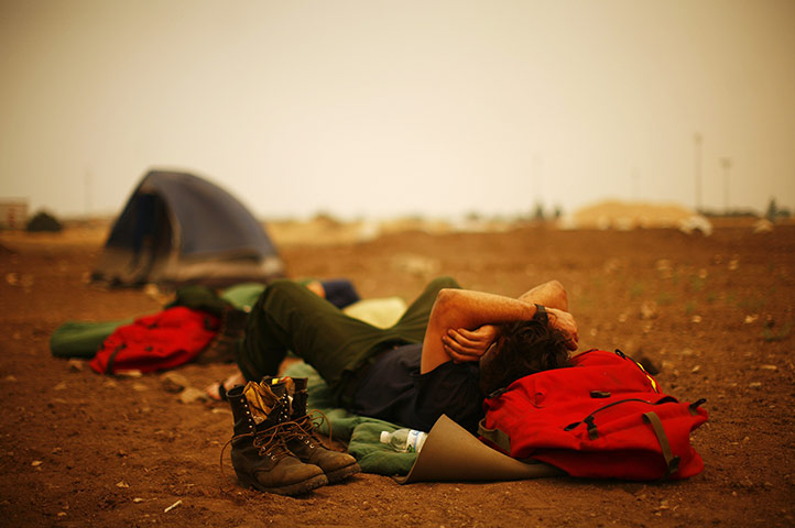 Arizona Wildfires: A firefighter sleeps at the incident command post