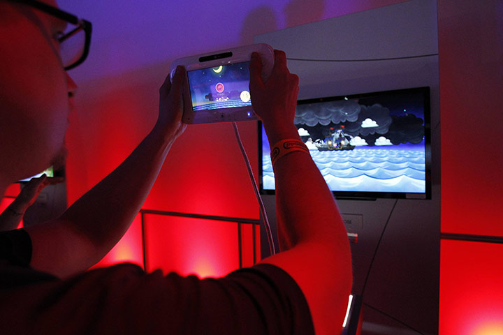 Week in Business: An attendee plays with the new Nintendo Wii U controller at E3