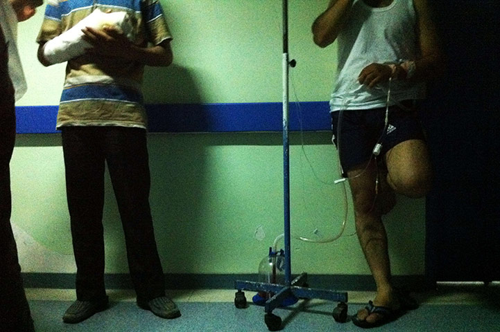 Syrian Refugees: Two Syrian injured men talk with a journalist