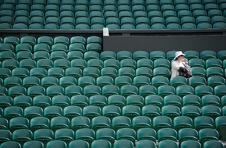 Wimbledon day 11: A lone spectator on Centre Court taking pictures for posterity