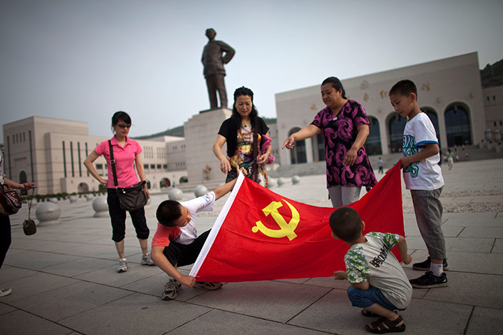 Communist Party 90th: Tourist holding flag in Yan'an, 90th anniversary of Communist Party