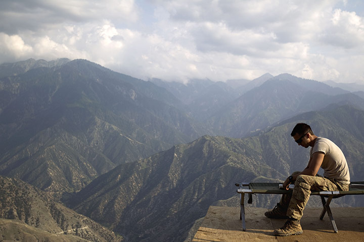 24 hours: Kunar province, Afghanistan: A US soldier reads a book 