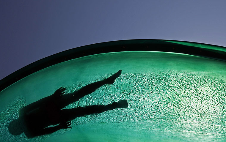 24 hours: Mogyorod, Hungary: A boy enjoys a water chute in an aqua arena
