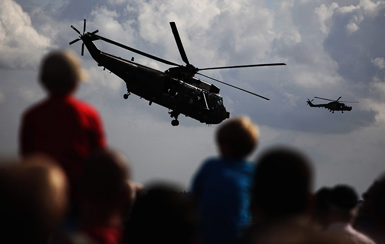 24 hours: Yeovil, England:  Crowds watch military helicopters during a aerial display