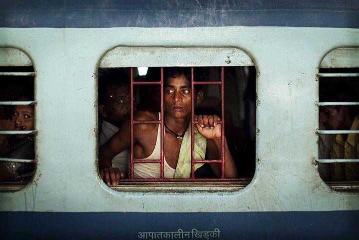  24 hours: New Delhi, India: A train passenger waits on a delayed train