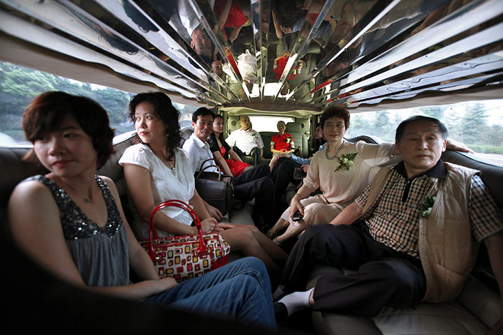 Luxury cars in China: people sit inside a Hammer Limousine in China