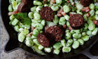 Fresh broad beans with black sausage and garlic shoots recipe