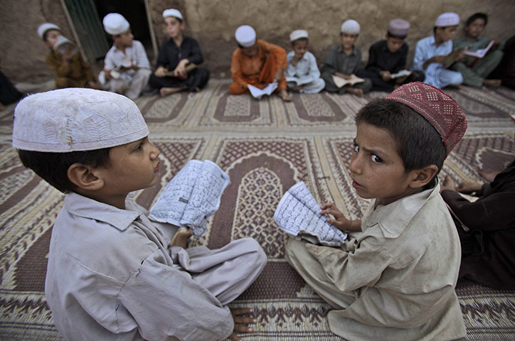 24 hours in pictures: Boys attend a religious class in a mosque  inIslamabad, Pakistan