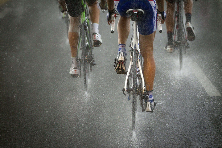 24 hours in pictures: Tour de France competitors riding under in the rain