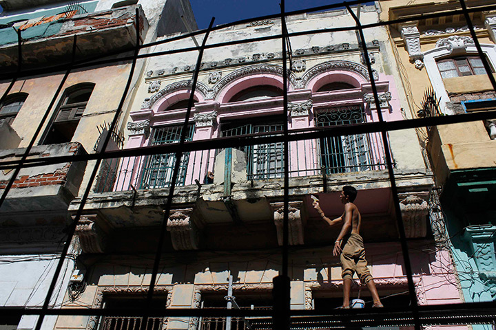 24 hours in pictures: A man repairs his house in Havana