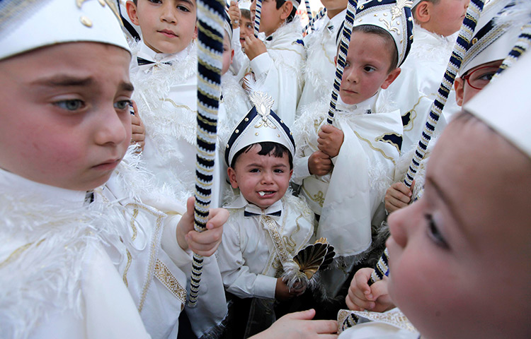 24 hours in pictures: Boys in traditional attire attend a ceremony, Turkey