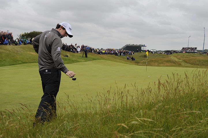 The Open: McIlroy taps at his club after a poor chip onto the 3rd green