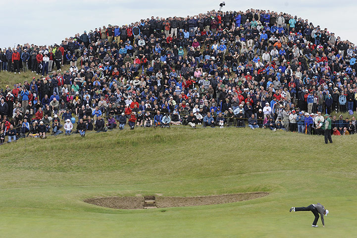 The Open: Rory McIlroy picks the ball from the cup after missing a short birdie putt