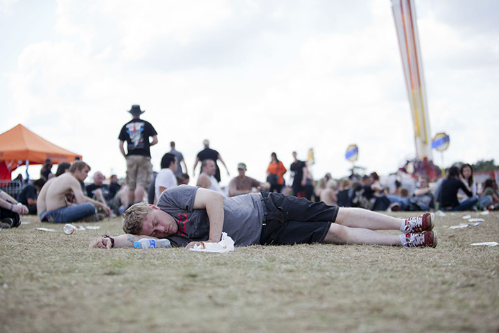 Sonisphere Festival: A man sleeps it off in the main arena on Sunday