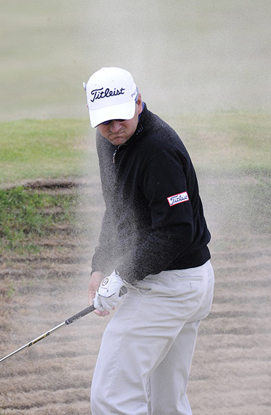 Open Golf: Ben Curtis gets a face full of sand as he plays out of a fairway bunker
