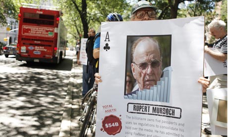 A demonstrator in New York holds a sign denouncing  Rupert Murdoch