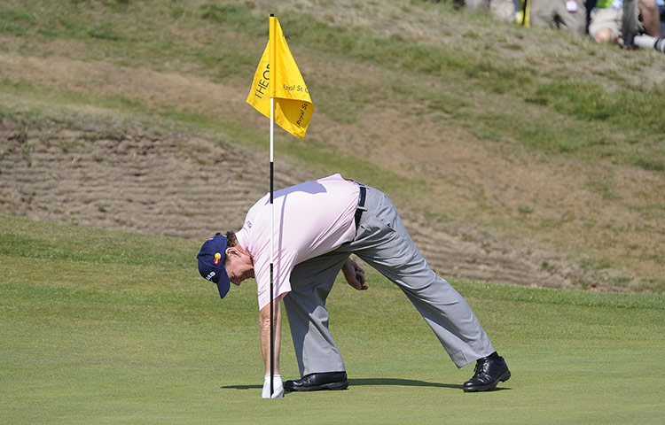 Tom Watson Hole in One: Tom Watson picks his ball from the hole after his hole in one