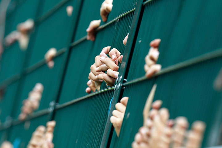 24 hours in pictures: Inter Milan supporters grab the fence during a match, Italy