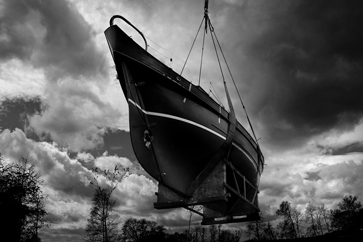 Boat: The Naida is slung out of the yard to be transported down to the water