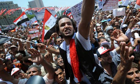 Egyptian protesters wave their national flag and shout slogans in Cairo's Tahrir Square