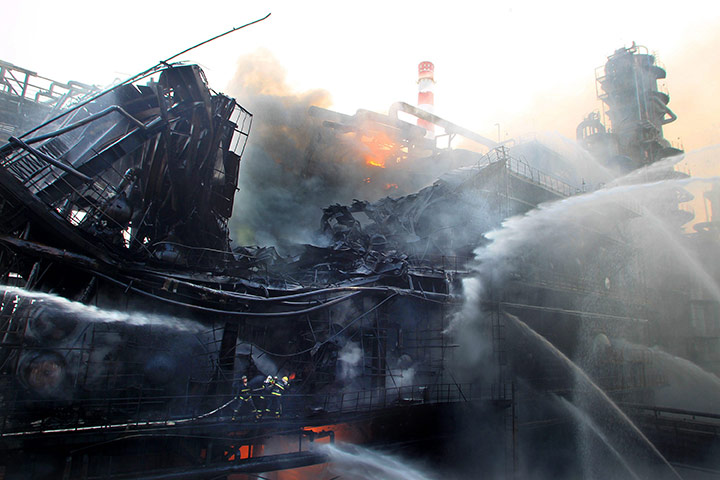 24 hours: Dalian, China: Firemen try to control a fire at a refinery facility