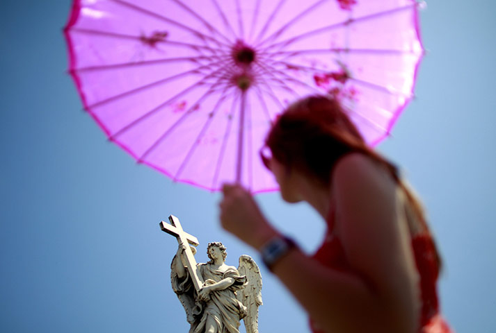 24 hours: Rome, Italy: A tourist uses an umbrella to shade herself from the sun
