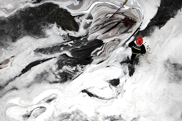 24 hours in pictures: Firefighters battle the fire at the Dalian Petrochemical Company