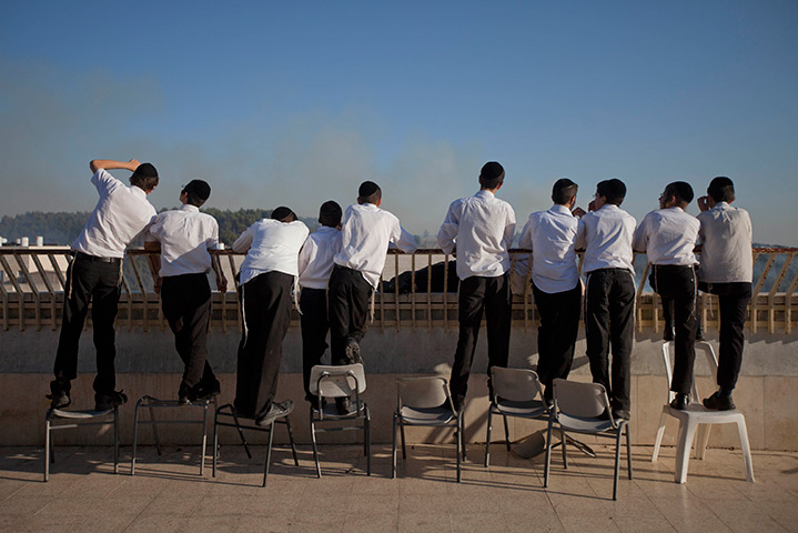 24 hours in pictures: Ultra-Orthodox Jewish boys watch fire below Yad Vashem Holocaust memorial